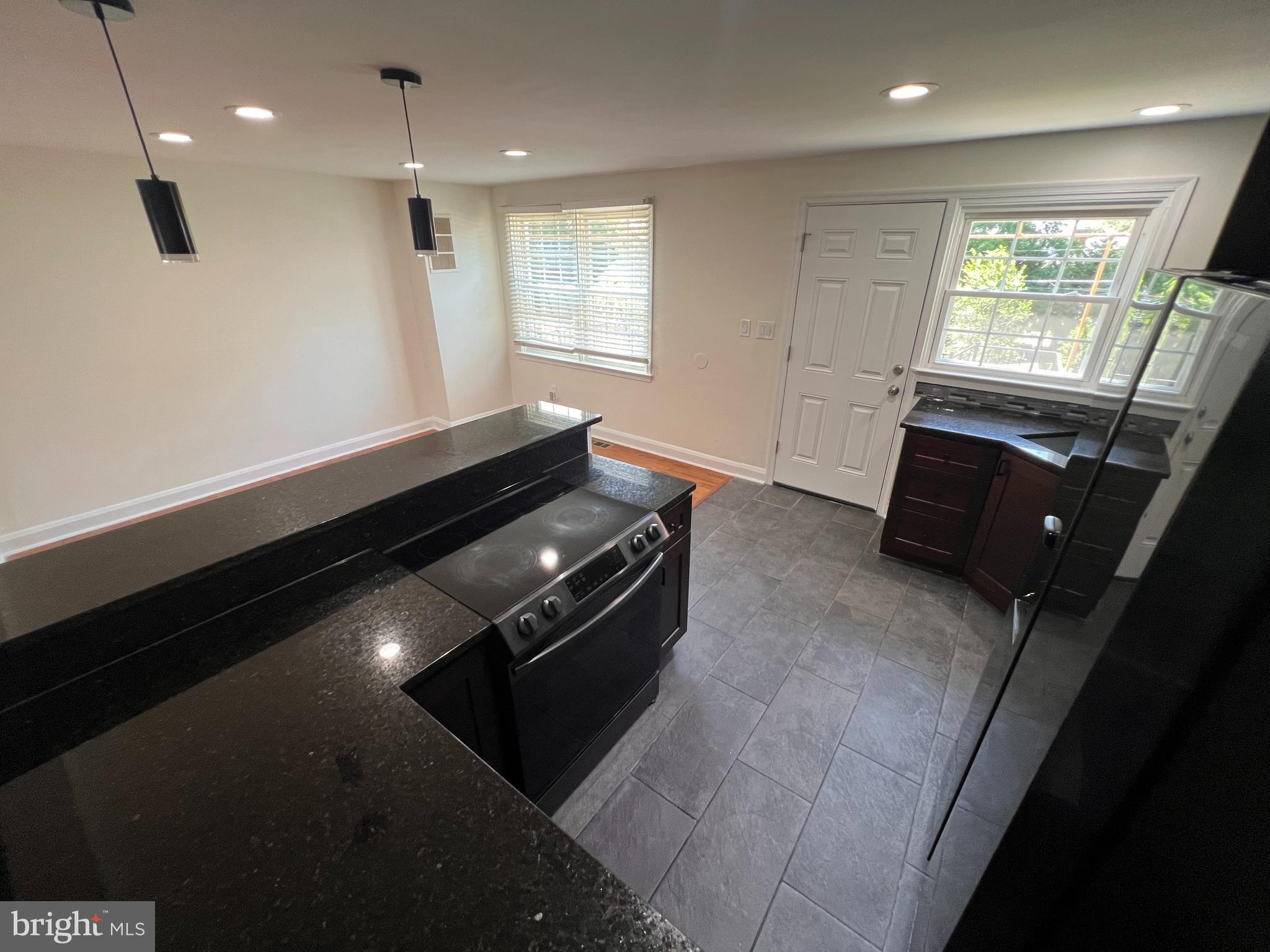 1583 Doxbury Road Towson, MD 21286 - Photo 6 of 31 a open kitchen with granite countertop a stove top oven a sink and dishwasher