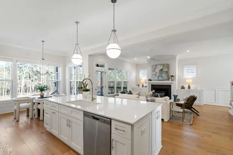 a kitchen with stainless steel appliances kitchen island a sink stove and refrigerator