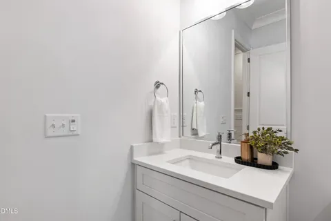 a dining room with furniture a chandelier and wooden floor