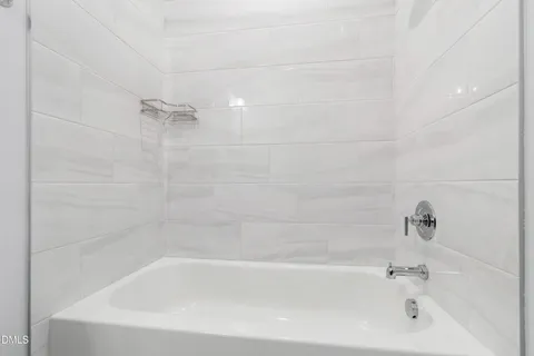 a spacious bedroom with a bed and a large window