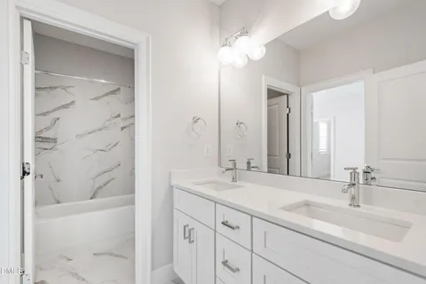 a bathroom with a double vanity sink and a mirror