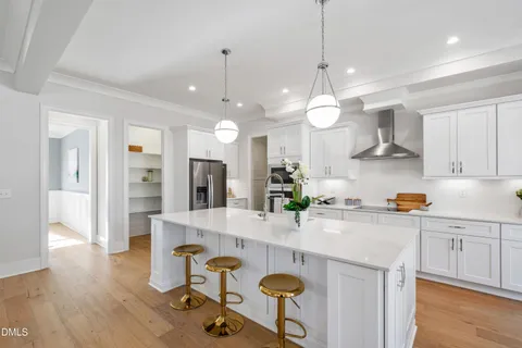 a kitchen with stainless steel appliances granite countertop a sink and a refrigerator
