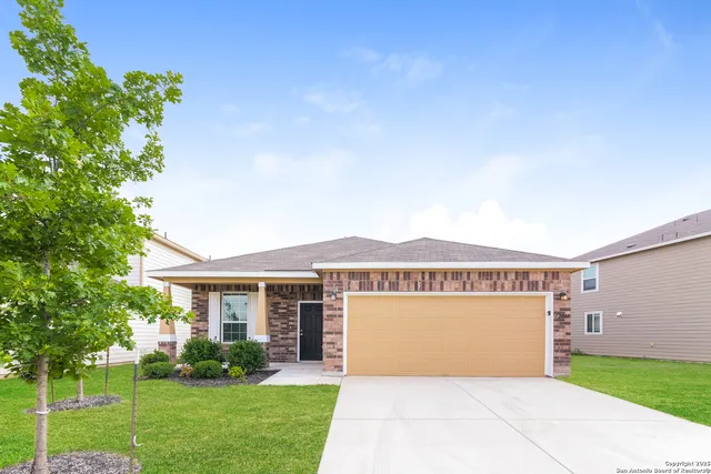 a front view of house with a garden