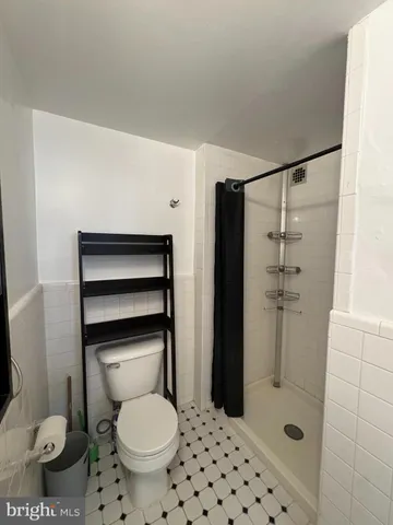 a living room with furniture a chandelier and a large window