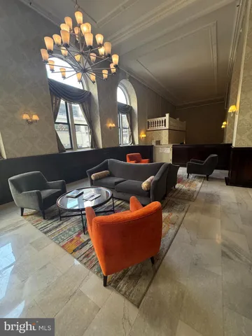 a living room with furniture potted plant and a window