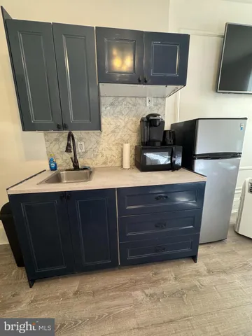 a reading room with wooden floor and furniture