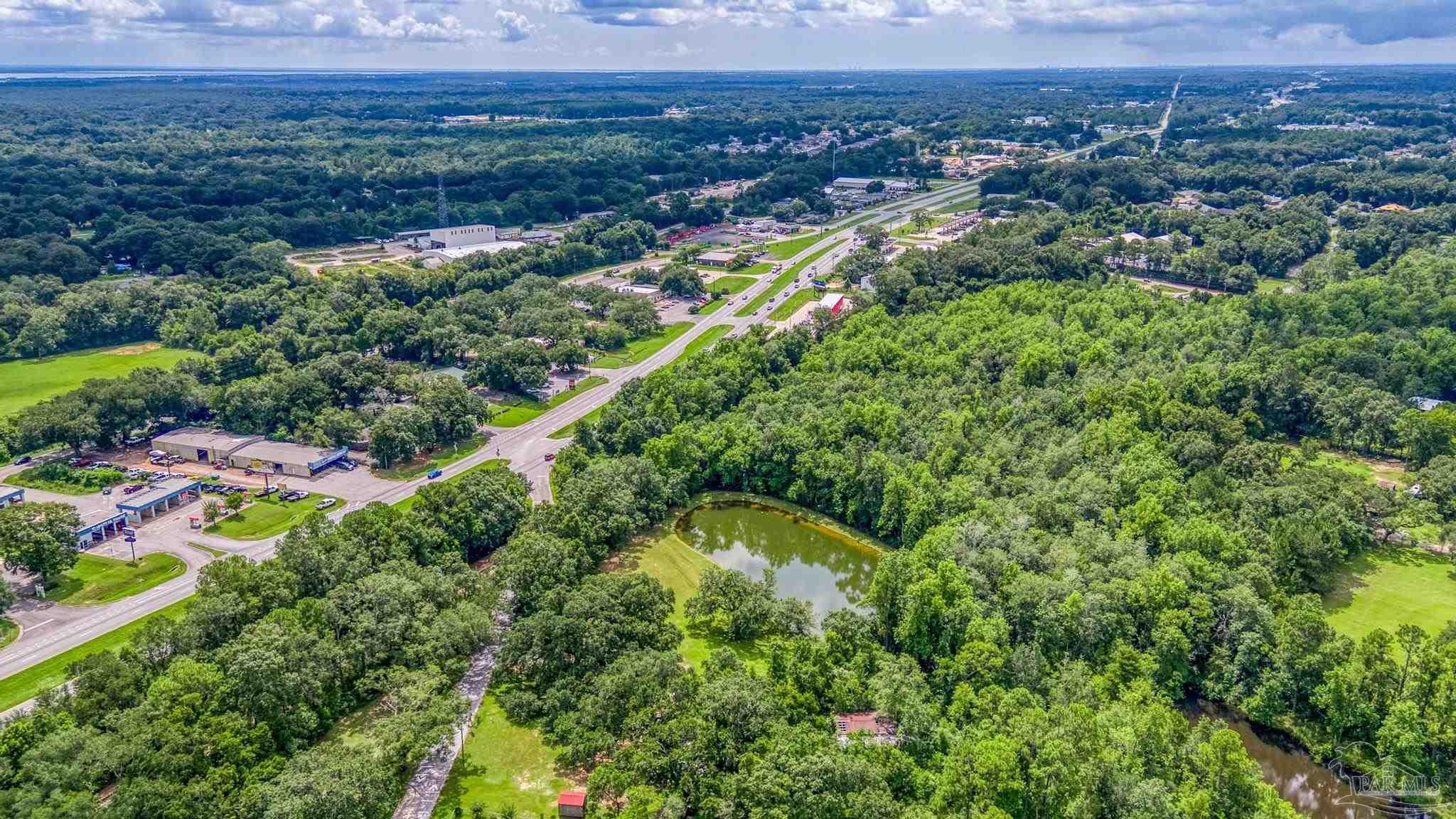 2345 Pompano Street Cantonment, FL 32533 - Photo 32 of 48 an aerial view of residential house with outdoor space and garden
