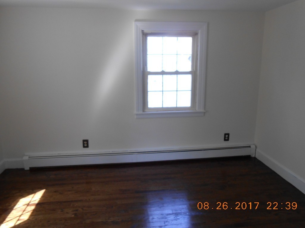 2338 Wilbraham Road Springfield, MA 01129 - Photo 7 of 17 an empty room with wooden floor and cabinets