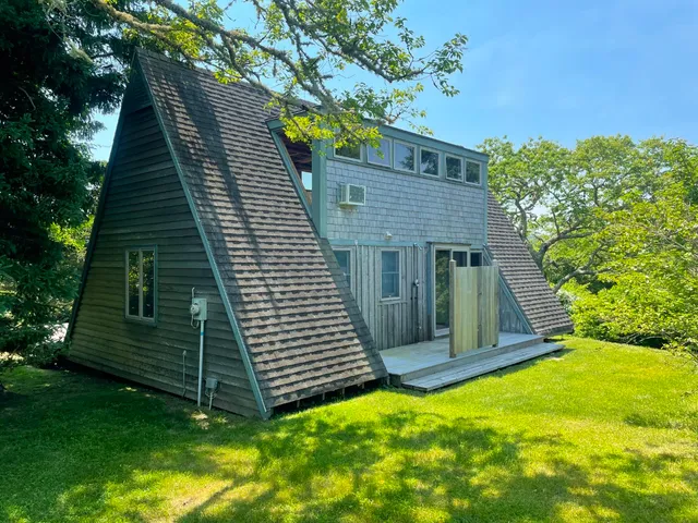an aerial view of houses covered in trees