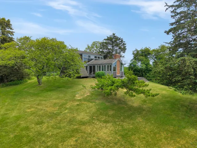 a view of a big yard with large trees