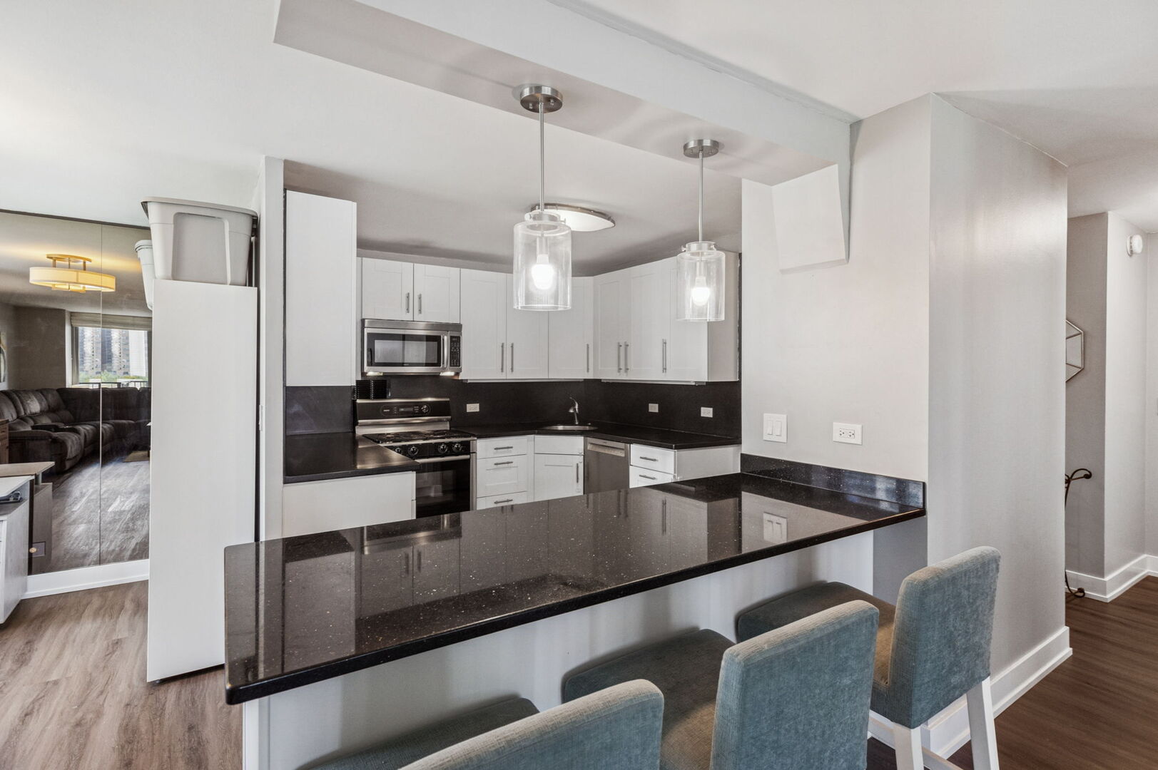 400 East Randolph Street, Unit 930 Chicago, IL 60601 - Photo 8 of 34 a kitchen with stainless steel appliances granite countertop a sink a stove and refrigerator