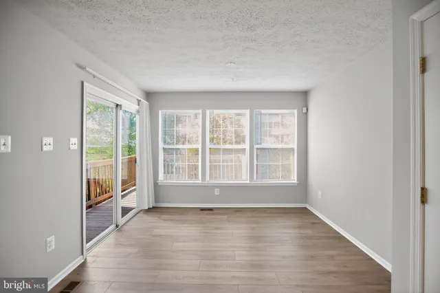 a view of kitchen with stainless steel appliances with refrigerator