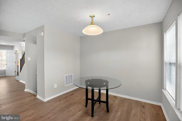a view of kitchen with furniture and wooden floor