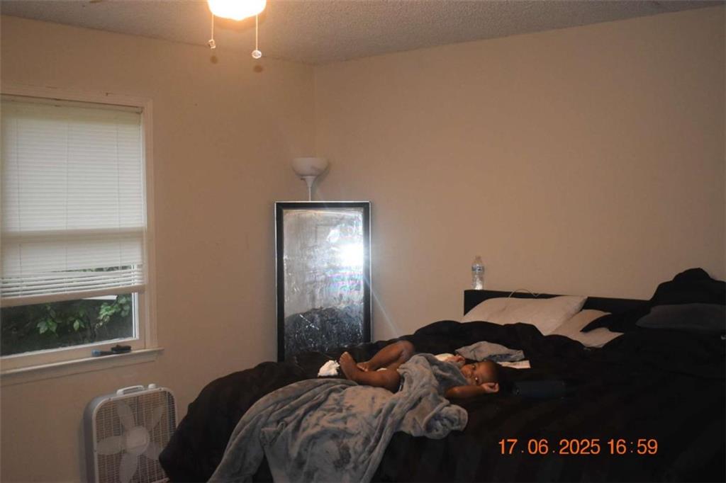 4433 Azalea Drive Macon, GA 31210 - Photo 20 of 24 a bedroom with a bed window and mirror