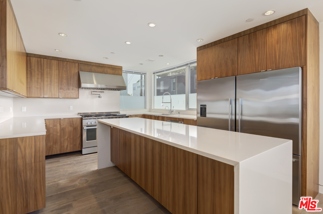 806 Brooks Avenue Venice, CA 90291 - Photo 8 of 29 a kitchen with stainless steel appliances kitchen island granite countertop a sink a stove and a refrigerator