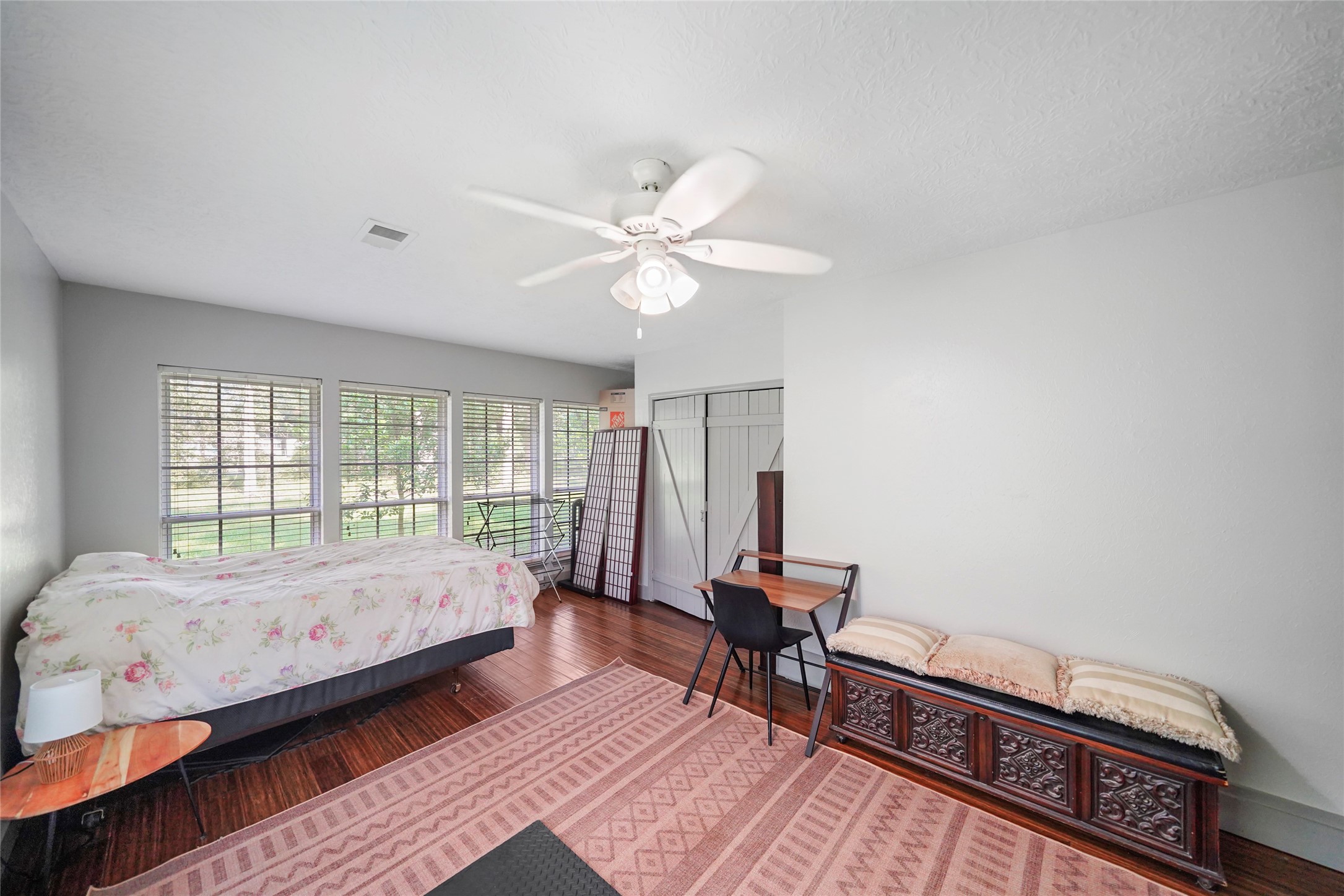 7477 Hidden Acres Drive Cleveland, TX 77328 - Photo 14 of 31 a bedroom with a bed and wooden floor