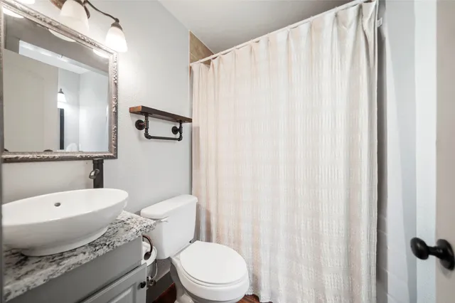 a white toilet sitting next to a bathroom sink