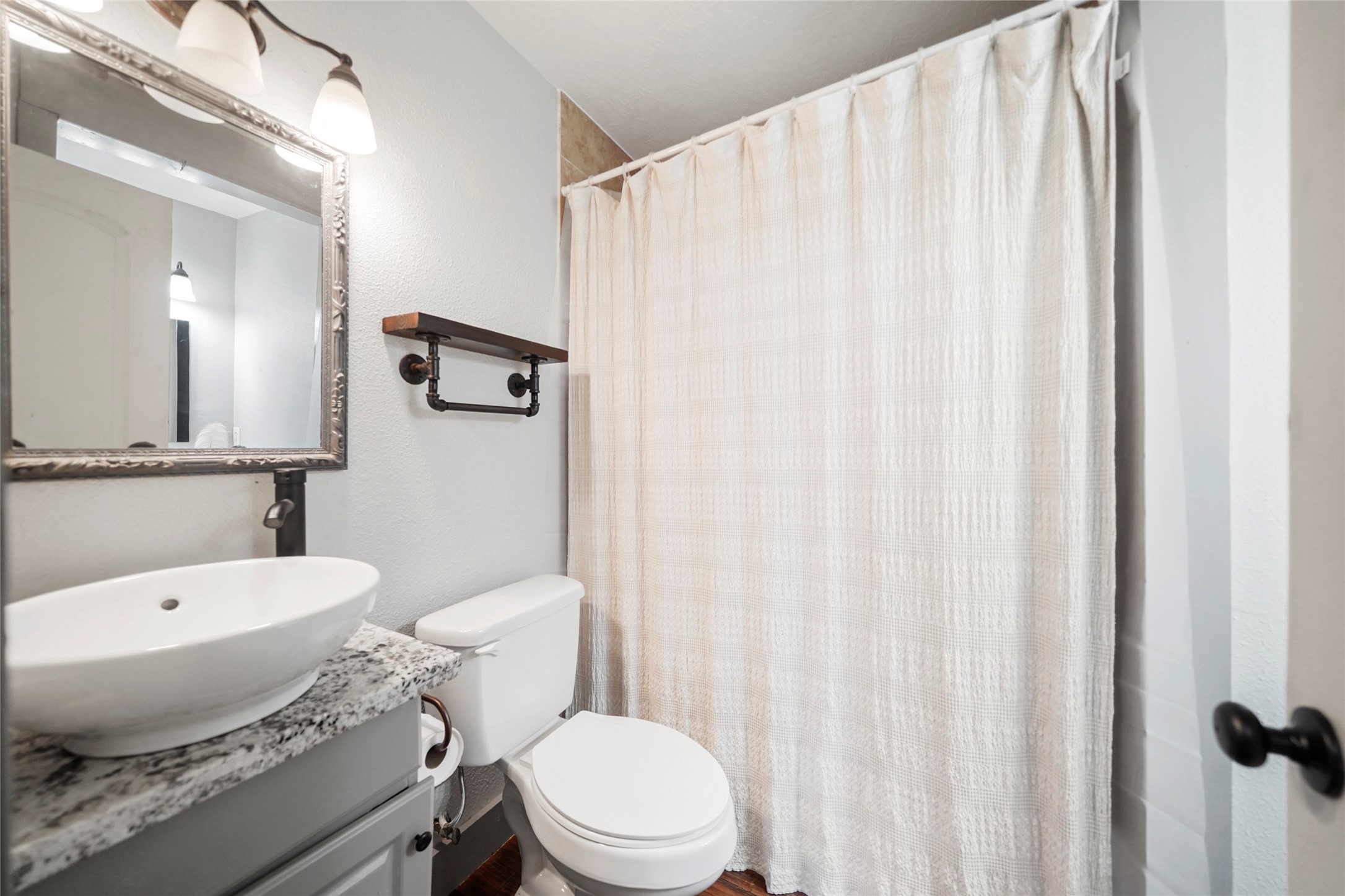 7477 Hidden Acres Drive Cleveland, TX 77328 - Photo 20 of 31 a white toilet sitting next to a bathroom sink