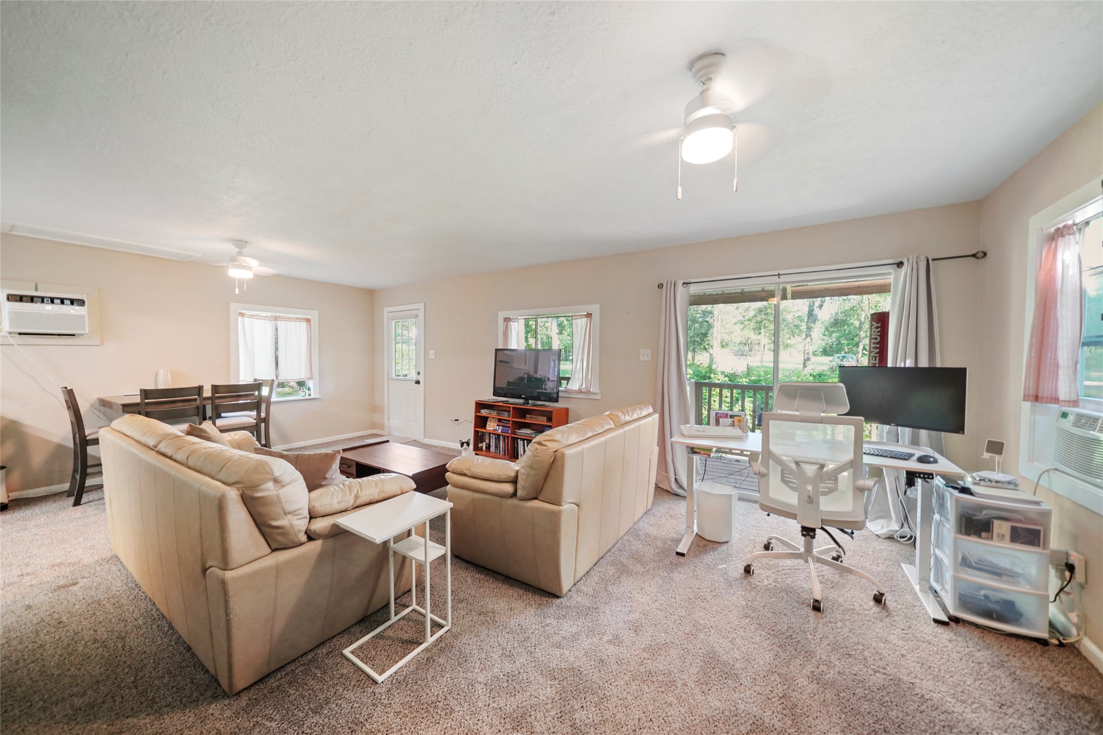 7477 Hidden Acres Drive Cleveland, TX 77328 - Photo 24 of 31 a living room with furniture and a flat screen tv