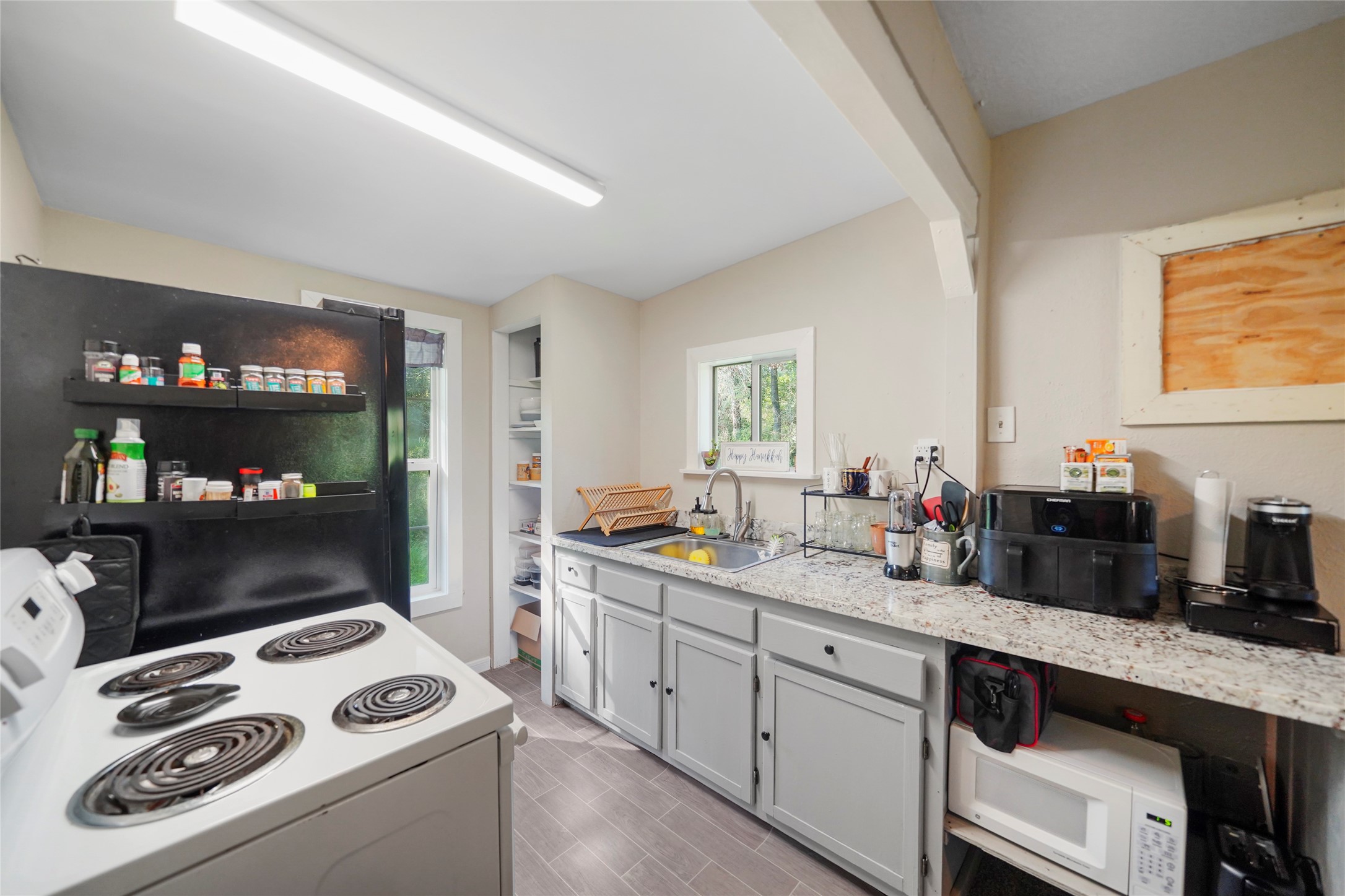 7477 Hidden Acres Drive Cleveland, TX 77328 - Photo 26 of 31 a kitchen with sink cabinets and appliances