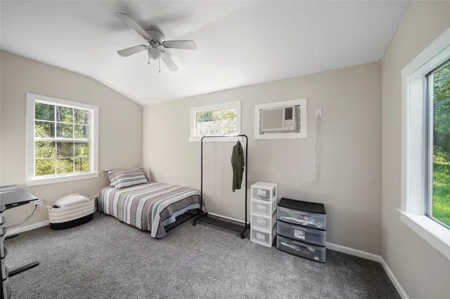 a spacious bedroom with a bed and a window