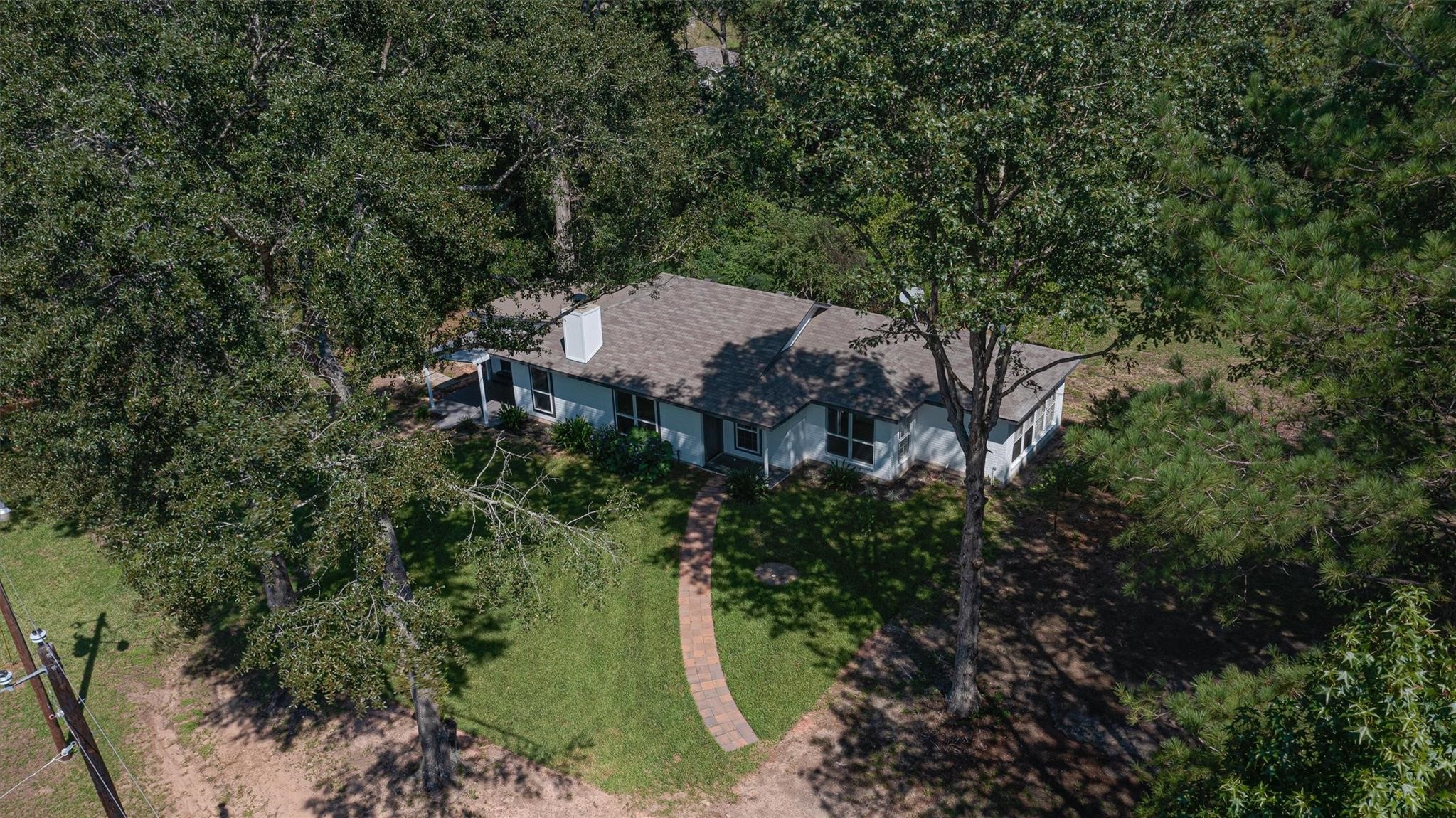 7477 Hidden Acres Drive Cleveland, TX 77328 - Photo 31 of 31 an aerial view of a house with a yard and trees