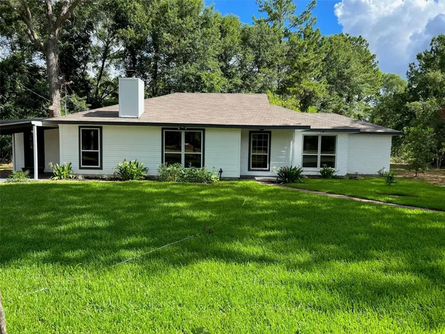 a front view of house with yard and green space