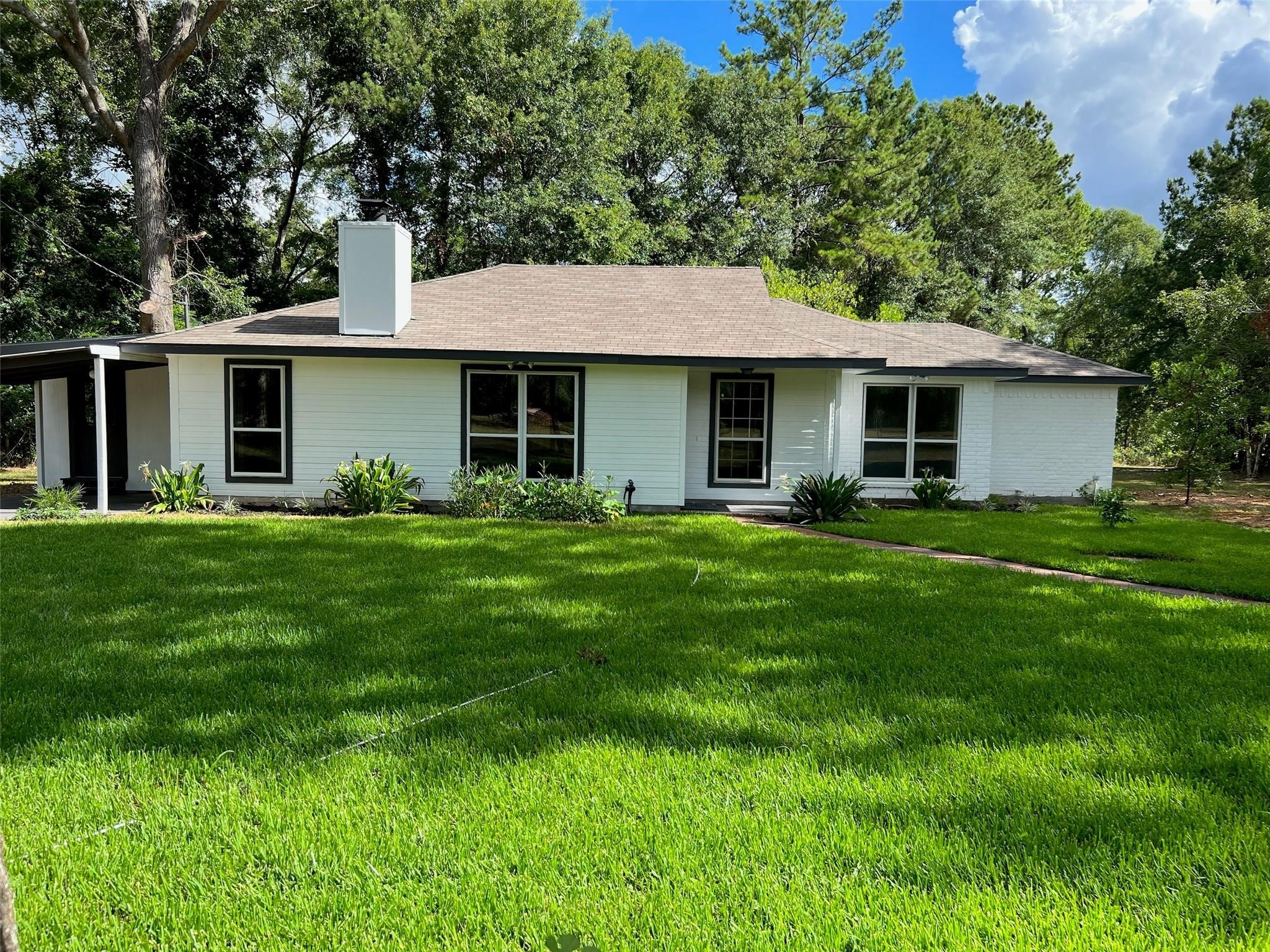 7477 Hidden Acres Drive Cleveland, TX 77328 - Photo 6 of 31 a front view of house with yard and green space