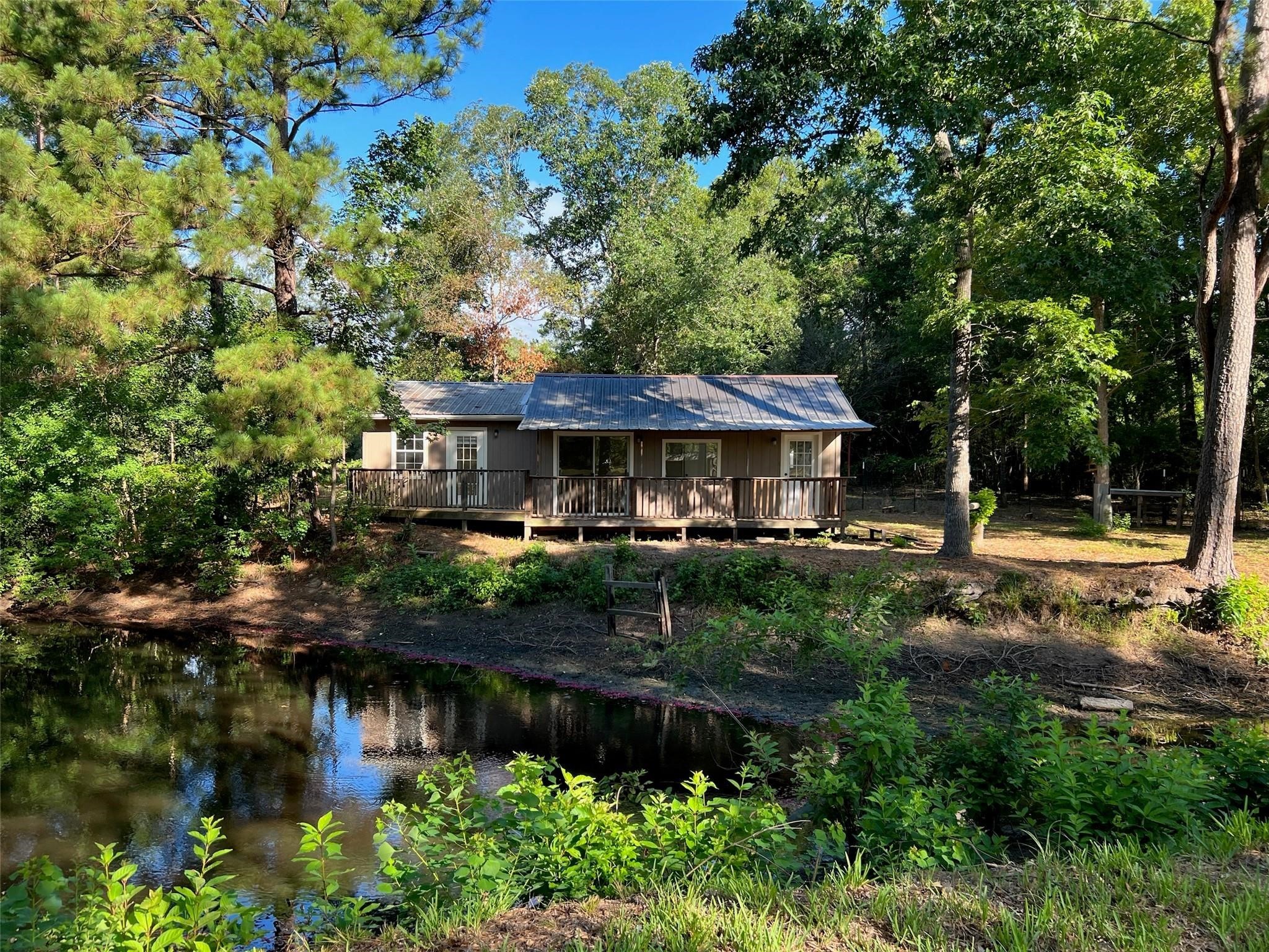 7477 Hidden Acres Drive Cleveland, TX 77328 - Photo 7 of 31 a front view of a house with a yard