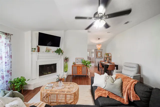 a living room with furniture a fireplace and a flat screen tv