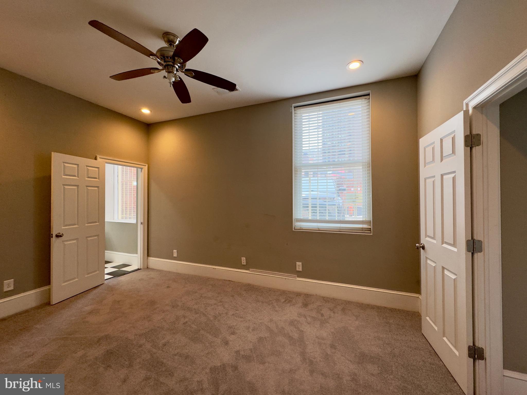 7 West Mulberry Street, Unit 4 Baltimore, MD 21201 - Photo 16 of 19 a view of a livingroom with a ceiling fan & windows