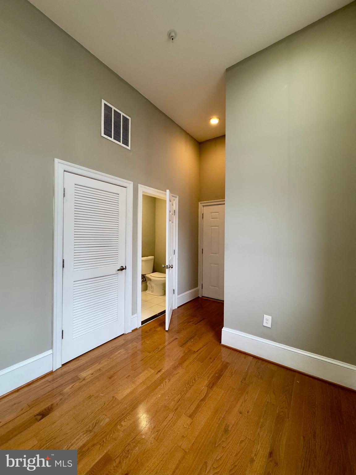 7 West Mulberry Street, Unit 4 Baltimore, MD 21201 - Photo 2 of 19 an empty room with wooden floor and closet
