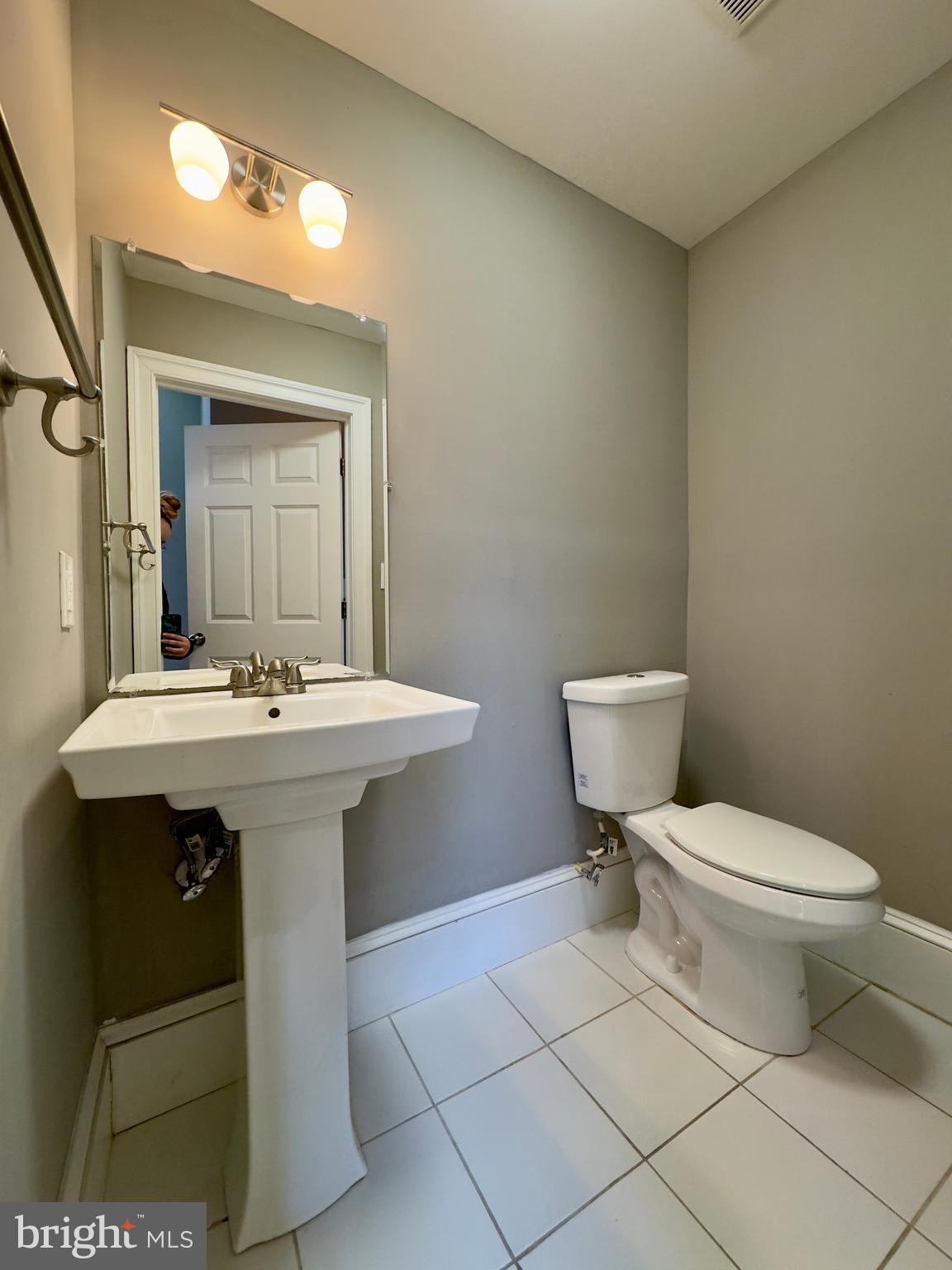 7 West Mulberry Street, Unit 4 Baltimore, MD 21201 - Photo 3 of 19 a bathroom with a sink toilet and a mirror