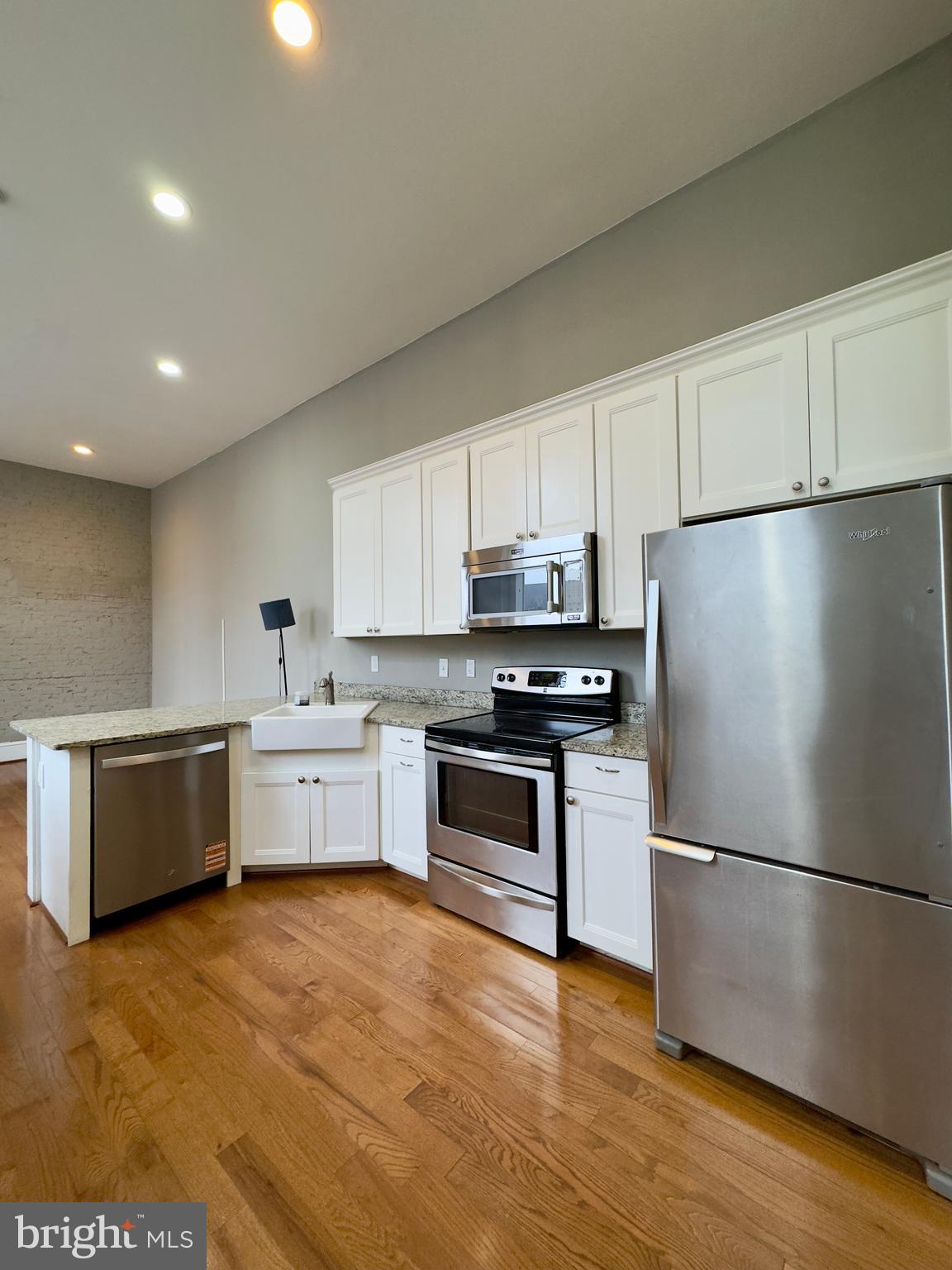 7 West Mulberry Street, Unit 4 Baltimore, MD 21201 - Photo 5 of 19 a kitchen with a refrigerator cabinets and wooden floor