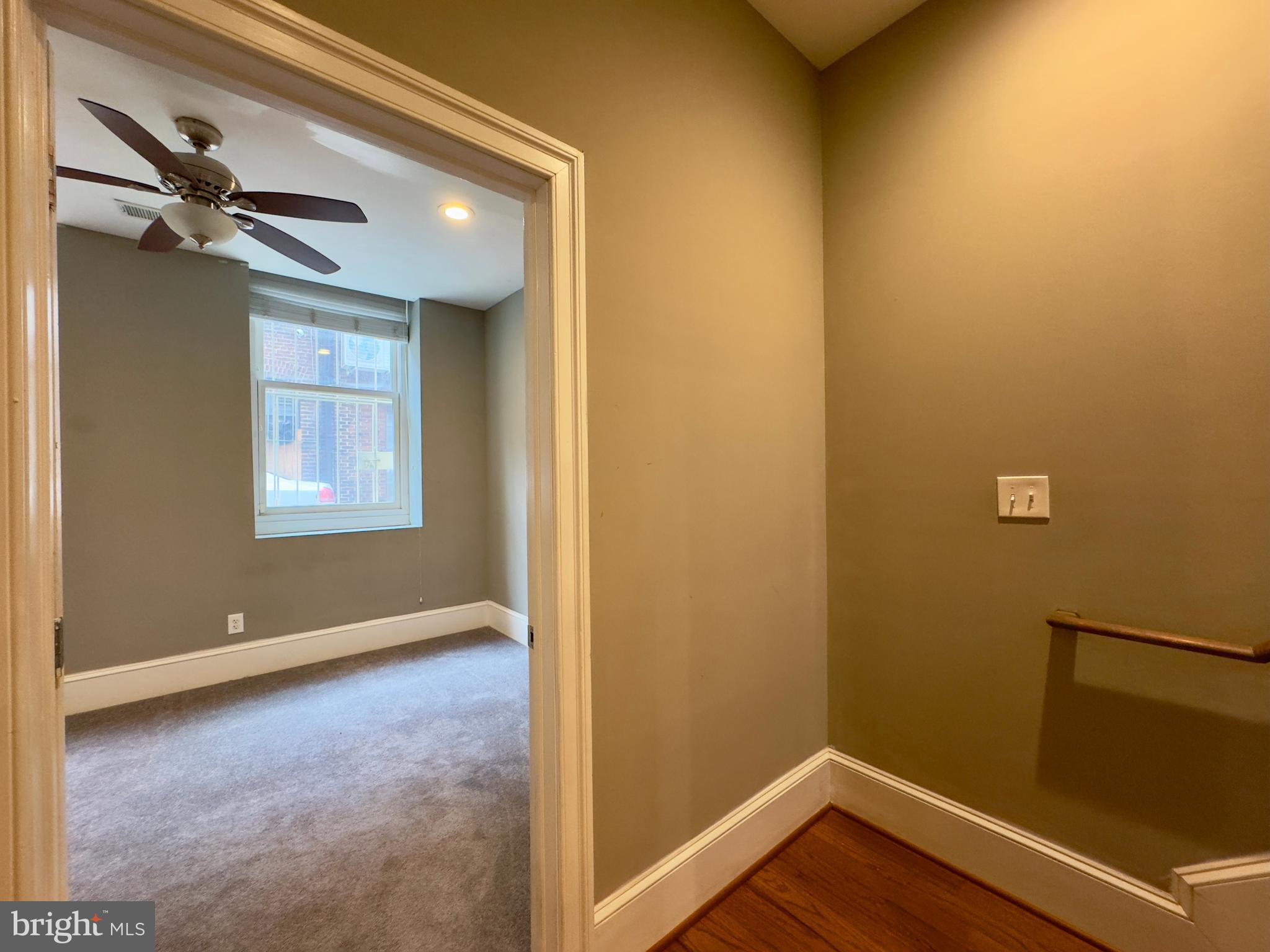 7 West Mulberry Street, Unit 4 Baltimore, MD 21201 - Photo 8 of 19 a view of an empty room with wooden floor and a window