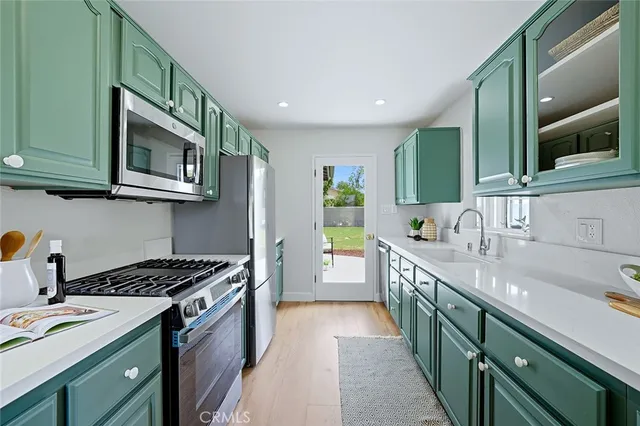 a kitchen with a sink stove top oven and cabinets