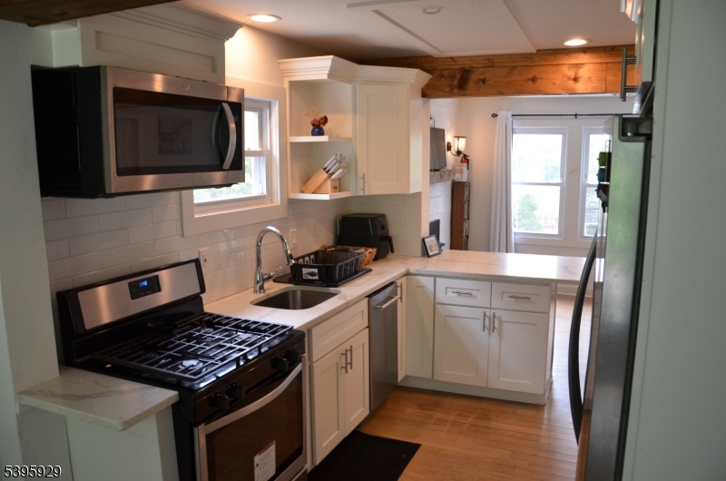 5 West Fairview Avenue Mine Hill, NJ 07803 - Photo 11 of 14 a kitchen with stainless steel appliances kitchen island granite countertop a stove and a sink