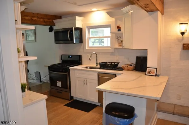 a bed sitting in a room next to a window