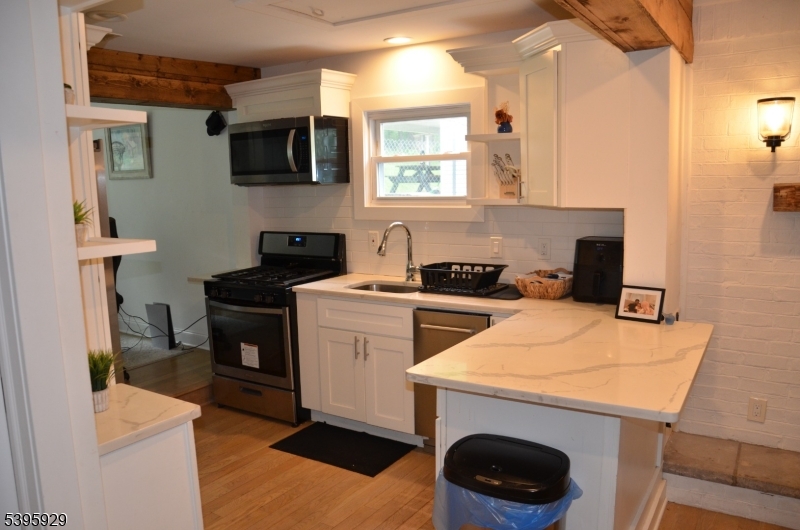 5 West Fairview Avenue Mine Hill, NJ 07803 - Photo 12 of 14 a kitchen with a sink a stove and a microwave