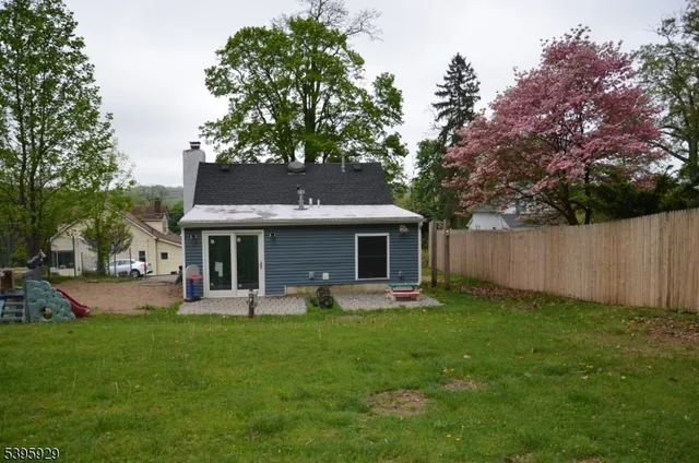 a front view of house with yard and outdoor seating