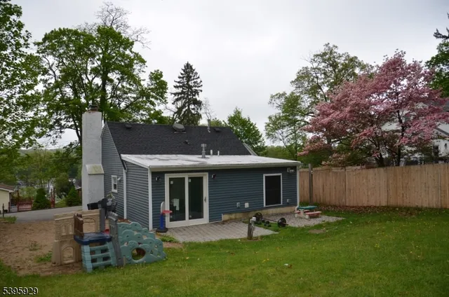 a view of a house with a yard and sitting area