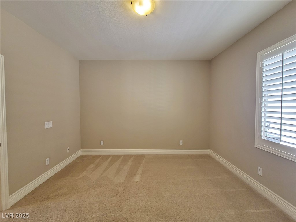 57 Tall Ruff Drive Las Vegas, NV 89148 - Photo 14 of 45 Empty room featuring light carpet and baseboards