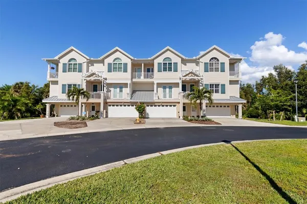 a front view of a house with yard and green space