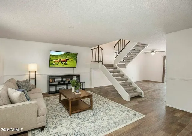 a living room with furniture and stairs