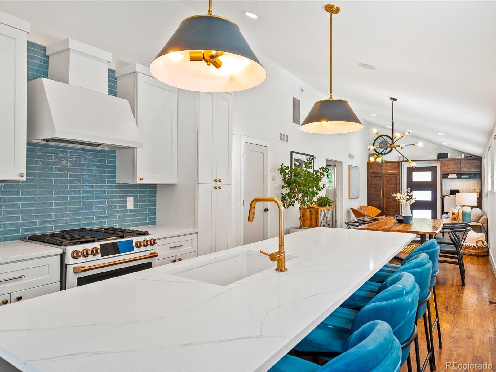 2289 Hudson Street Denver, CO 80207 - Photo 11 of 44 a kitchen with a table and chairs