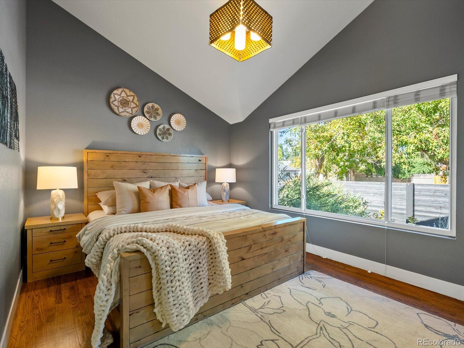 2289 Hudson Street Denver, CO 80207 - Photo 14 of 44 a bedroom with a bed and a large window