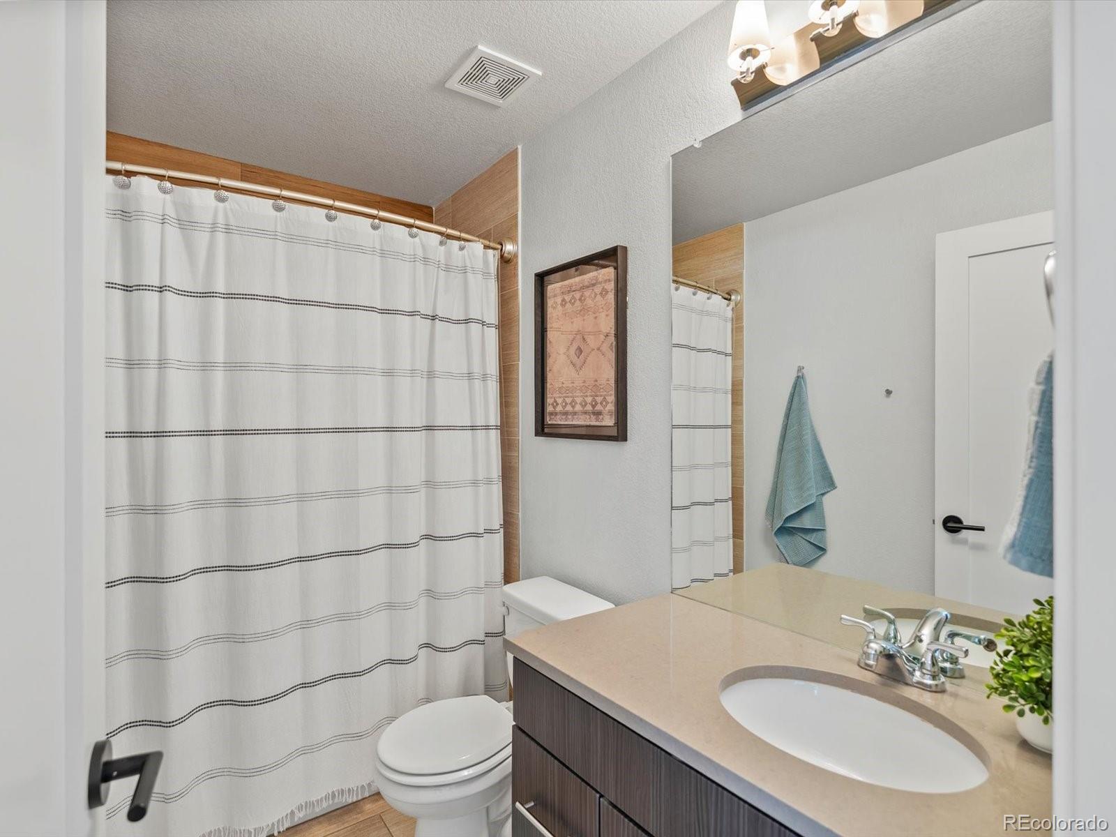 2289 Hudson Street Denver, CO 80207 - Photo 20 of 44 a bathroom with a sink toilet and shower