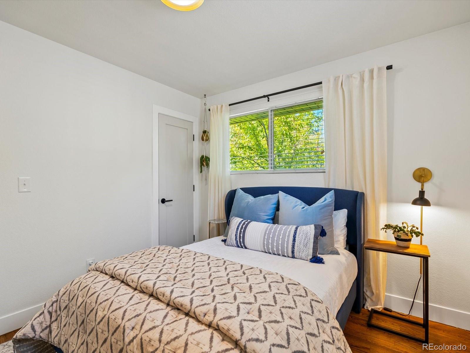 2289 Hudson Street Denver, CO 80207 - Photo 21 of 44 a bedroom with a bed and a window