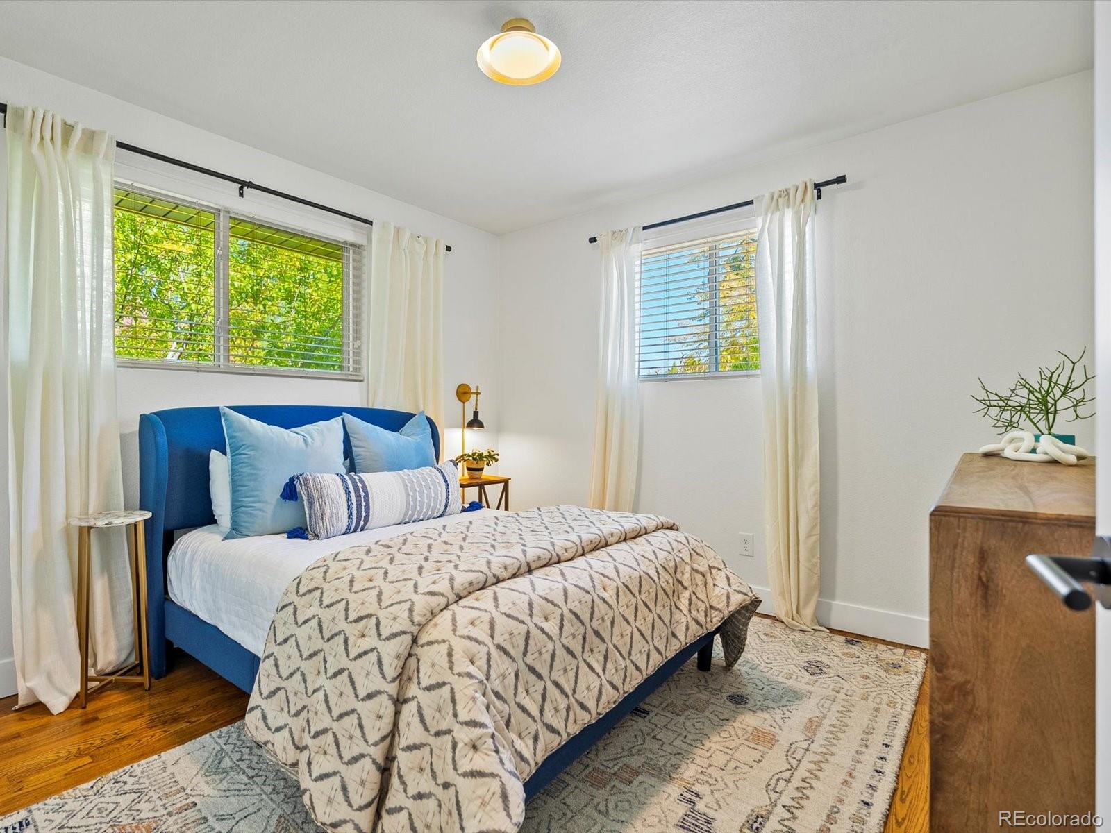 2289 Hudson Street Denver, CO 80207 - Photo 22 of 44 a bedroom with a bed and a window