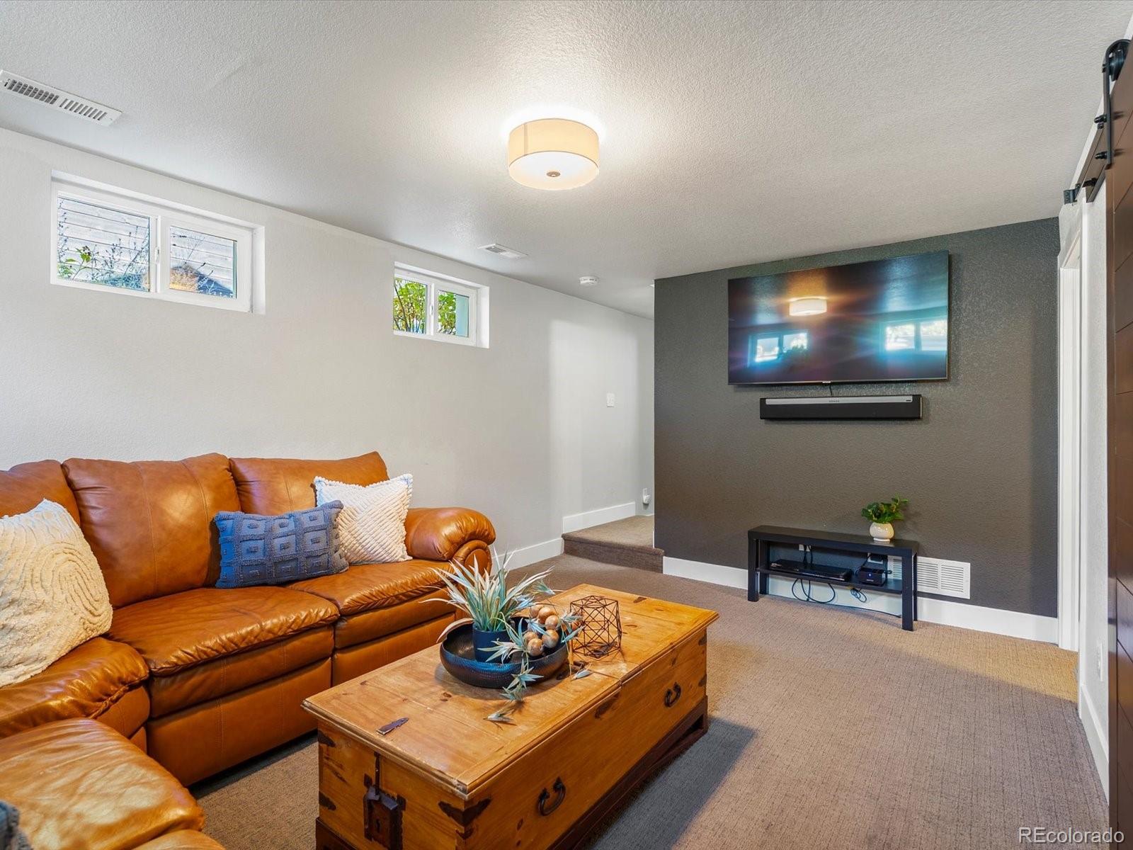 2289 Hudson Street Denver, CO 80207 - Photo 23 of 44 a living room with furniture and a lamp